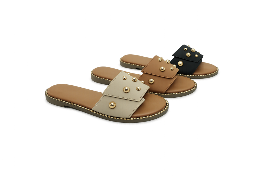 Flat slides in cream, tan, and black with metallic stud accents